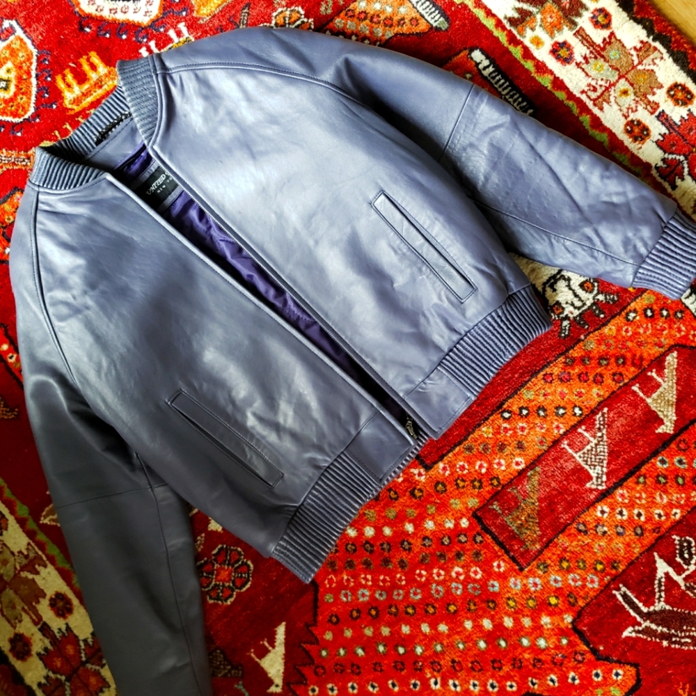 This is a lilac leather bomber jacket in size large with zip out quilted lining.